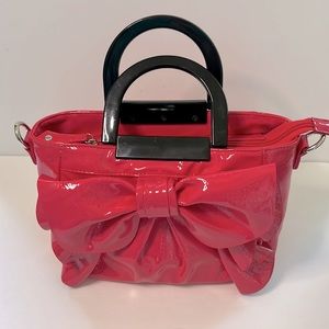 The perfect “Barbie” Hot Pink Patent bow-front ruffle purse.